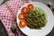 green noodles, or Spinach pasta , Zucchini raw vegan pasta dip, and tomatoes on plate.