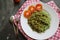 Green noodles, or Spinach pasta , Zucchini raw vegan pasta dip, and tomatoes on plate.