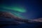 Green northen light changing itÂ´s shape with stars shining in polar night