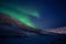 Green northen light changing itÂ´s shape with stars shining in polar night