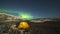 Green Northern Lights over Glowing Tent in Khibiny Mountains. Russia. Time Lapse