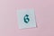 Green number 6 cross-stitch embroidered on piece of canvas in center of pink background. Hobbies, pastime, activity, art, handmade