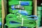 Green nylon soft lifting slings stacked in piles.