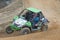 Green off road car in the turn in the race