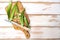 Green okra pods on cutting board with a knife. on white table. Copy space