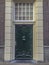 Green old Dutch door of a mansion