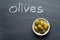 Green olives on blackboard