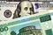 A green one hundred Belorussian ruble bank note with an American one hundred dollar bill