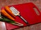 Green onion, carrot, grater on red plastic vintage kitchen board