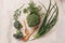 Green onions, broccoli, dill in a wooden bowl and wooden spoons