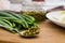 Green onions, chopped eggs on a plate and canned peas on a wooden board. The concept of cooking spring salad.