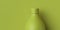 Green opaque bottle or flask on a green background