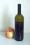 Green opened bottle with sweet red wine and apples