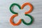 Green and orange horseshoes forming a clover.