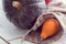 Green and orange pumpkin in a burlap pouch