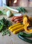 Green and orange vegetables on wooden table to prepare summer minestrone