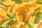 Green, orange and yellow Fusilli pasta background, selective foc