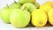 Green organic apples and lemons ordered on marble background