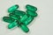 Green oval pills medication on white background