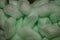 Green packing polystyrene shipping protecting foam peanuts close up modern background big size high quality print