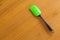 Green paddle on wooden background