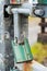 Green padlock on a metal gate