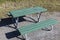 A green-painted bench with a table at the campsite