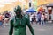 Green painted Man parades his snake replica during a town festivity to honor Patron Saint Paul the First Hermit Feast.