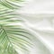 Green palm leaves pattern overlay on soft blur white fabric