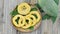 Green papaya and wicker basket with cut on wooden BACKGROUND