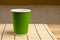 Green paper cup on bamboo stand. Ecological dishes