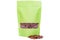 Green paper doypack stand up pouch with window zipper filled with coffee beans on white background