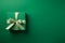 Green paper gift box on green background. Green friday, sustainable consumption, sustainability, zero waste concept. Top view.