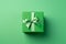 Green paper gift box on green background. Green friday, sustainable consumption, sustainability, zero waste concept. Top view.