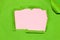 green paper is torn in the middle leaving pink copy space, creative art design, flat lay
