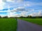 Green park in Liverpool, England, United Kingdom. Pathway through the grass with a cloudy sky