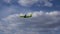 Green passenger air plane in the cloud sky