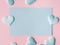 Green pastel card hearts on pink textured background