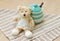 Green pastel porcelain jar and little bear doll with cute fabric.