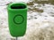 Green pastic garbage bin or can on street