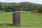 Green pasture with an antique wood silo