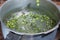 Green peas cooking in silver colored metal pot