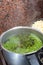 Green peas cooking in silver colored metal pot