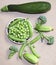 Green peas and pods, cucumbers and squash, still life,