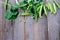 Green peas in pods freshly picked on wood background