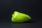 Green peppers on a black background. F