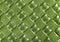 Green perforated leather texture. Close up shot. Leather background. Macro shot. The look of genuine leather. Leather pattern with