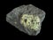 Green peridote olivine in dark basalt rock