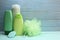 Green personal care products on wooden background