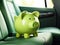 Green piggy bank in the car interior. The concept of purchasing, credit, leasing or car insurance